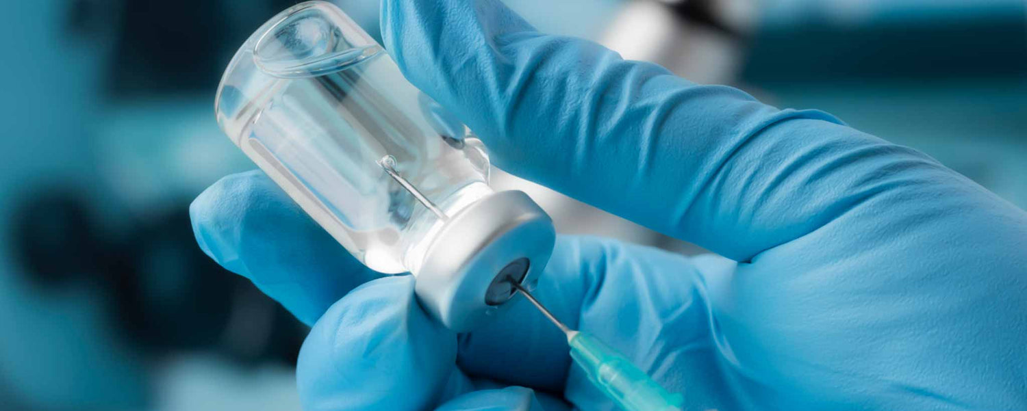 Hand holding vaccine vial