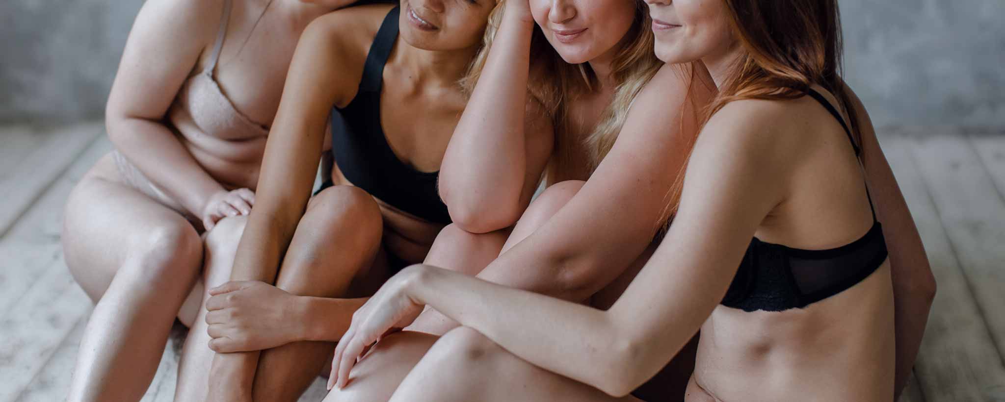 'Four female with underwear sit together.'
