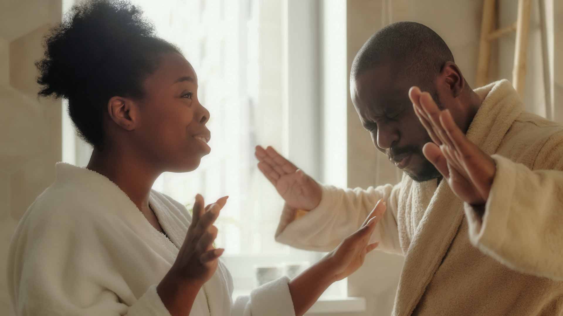 A Black couple arguing with emphatic hand gesture.
