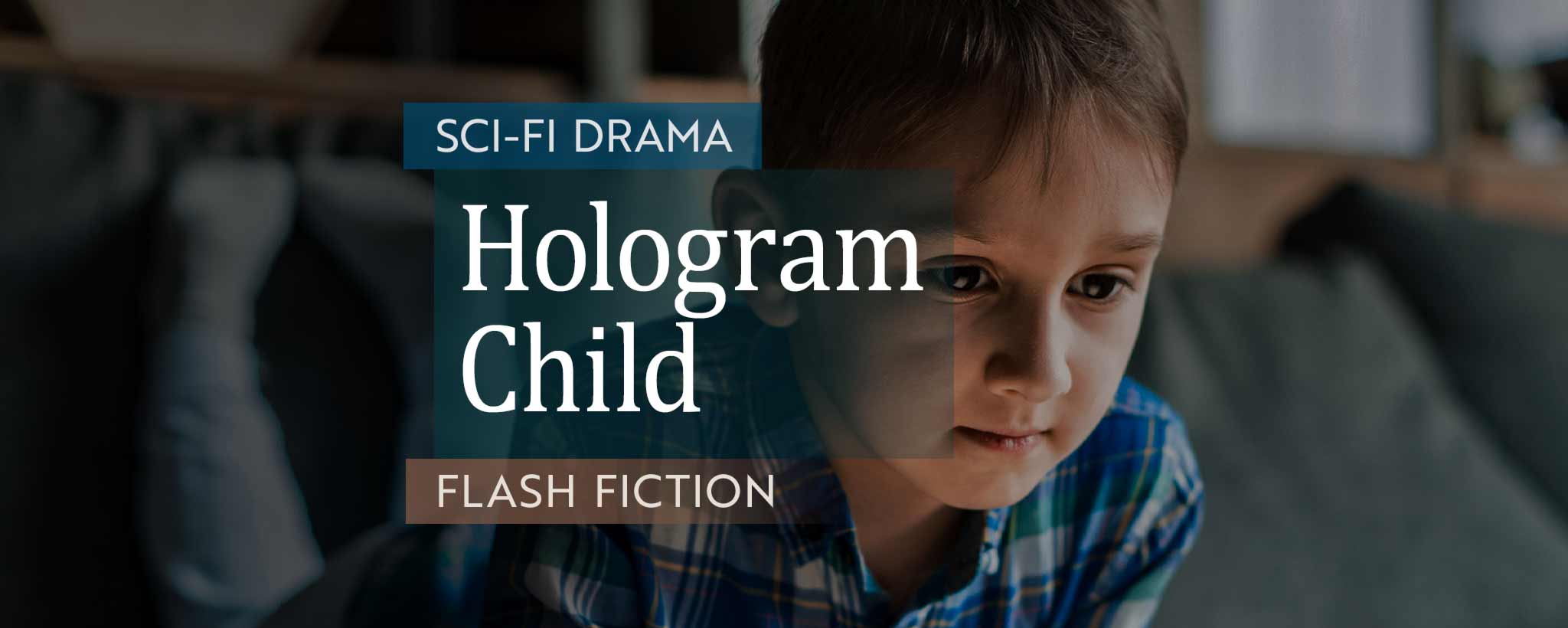 'A boy lies prone on a sofa while staring at a digital tablet.'