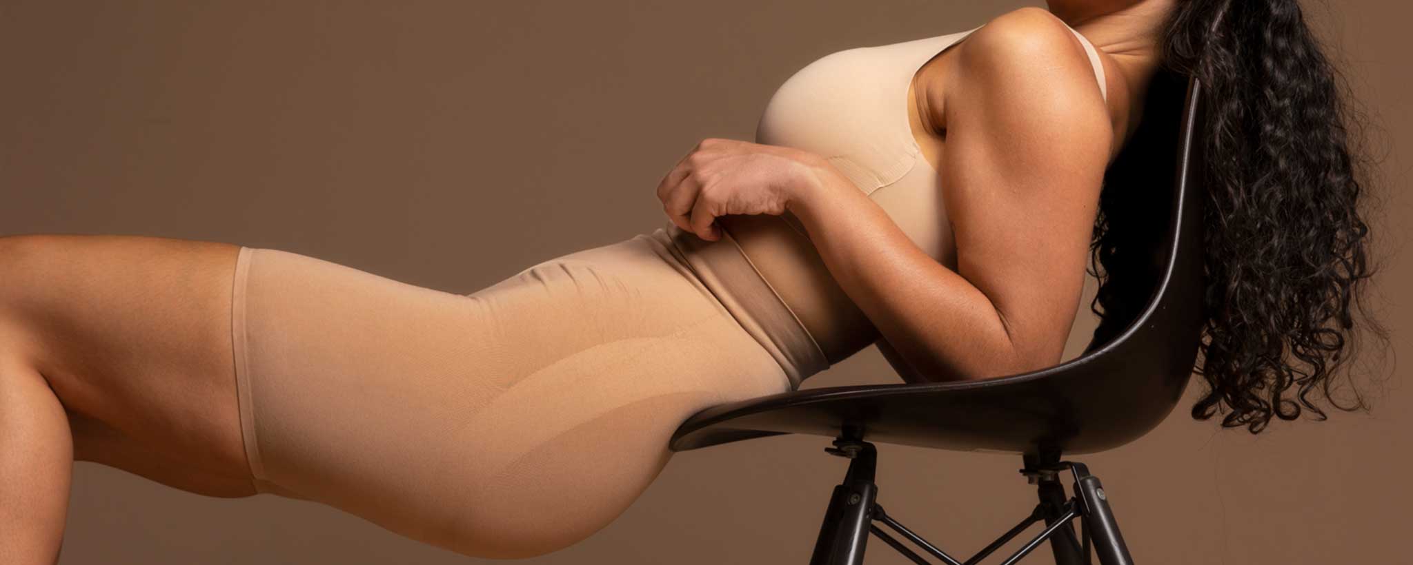 A profile of black female wearing shapewear.