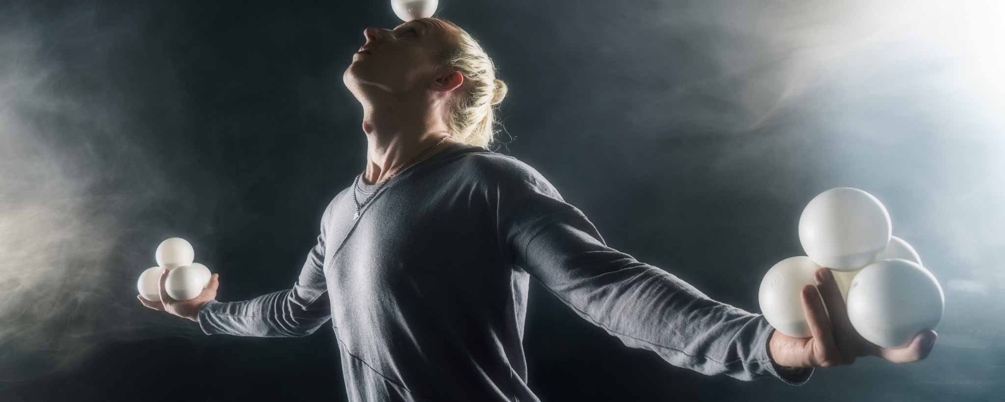 'Blonde man juggling balls'