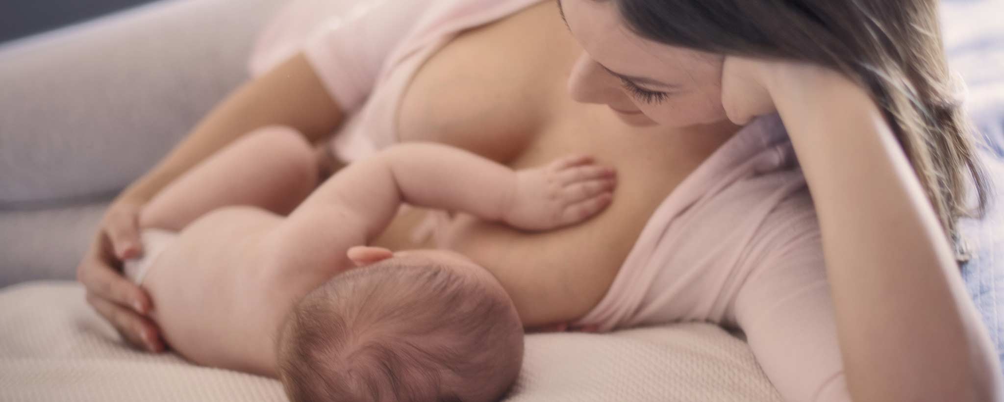 'Mother breastfeeding newborn baby'