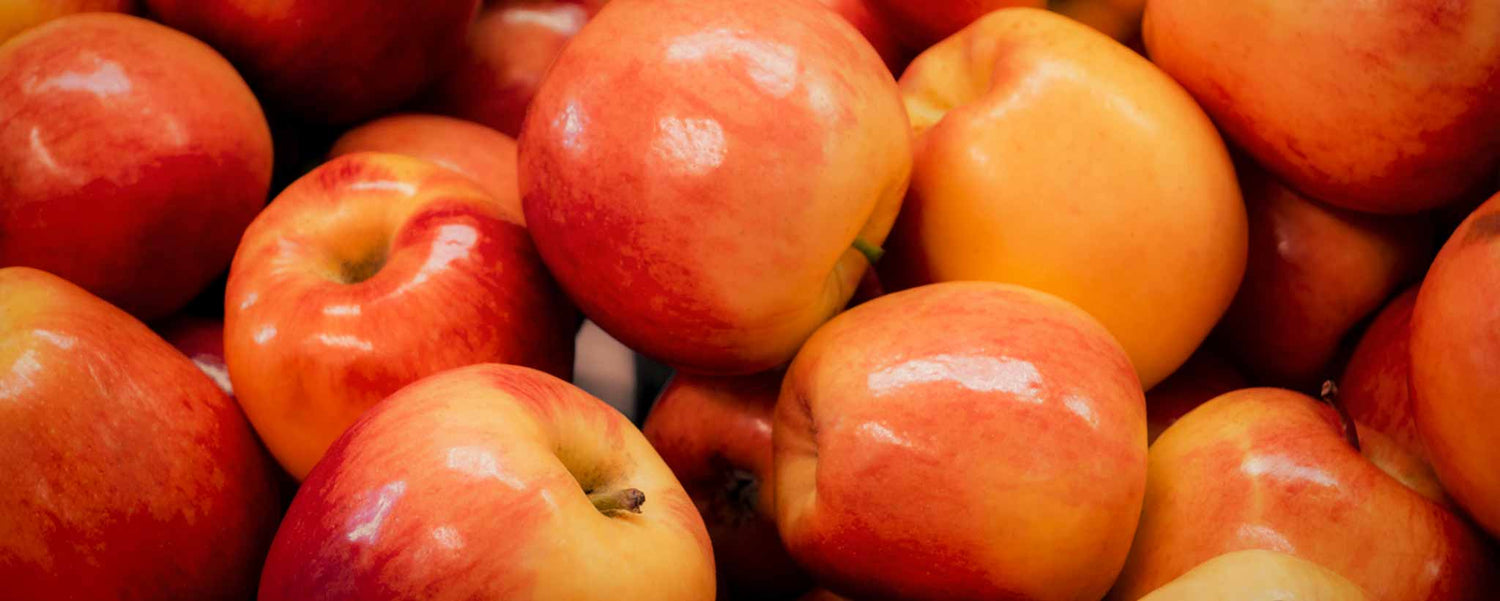 A bushel of red-orange apples.