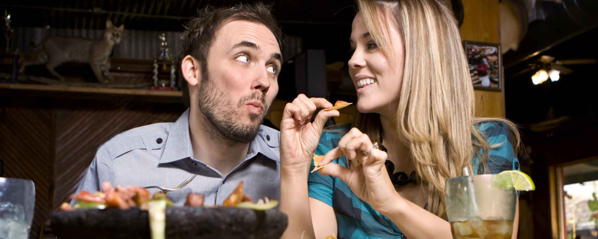 'Couple eating chips and salsa'