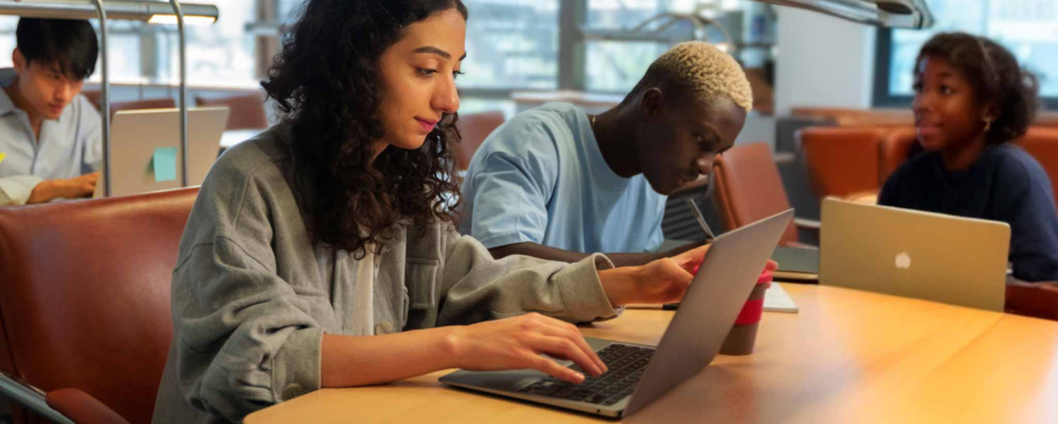 Students with laptops in classroom