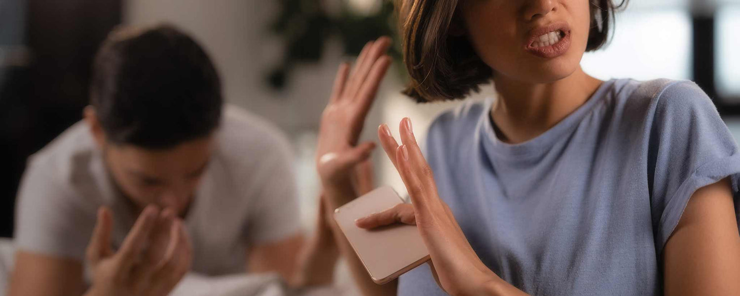 A lady holds up her hands in a defiant gesture during an argument.