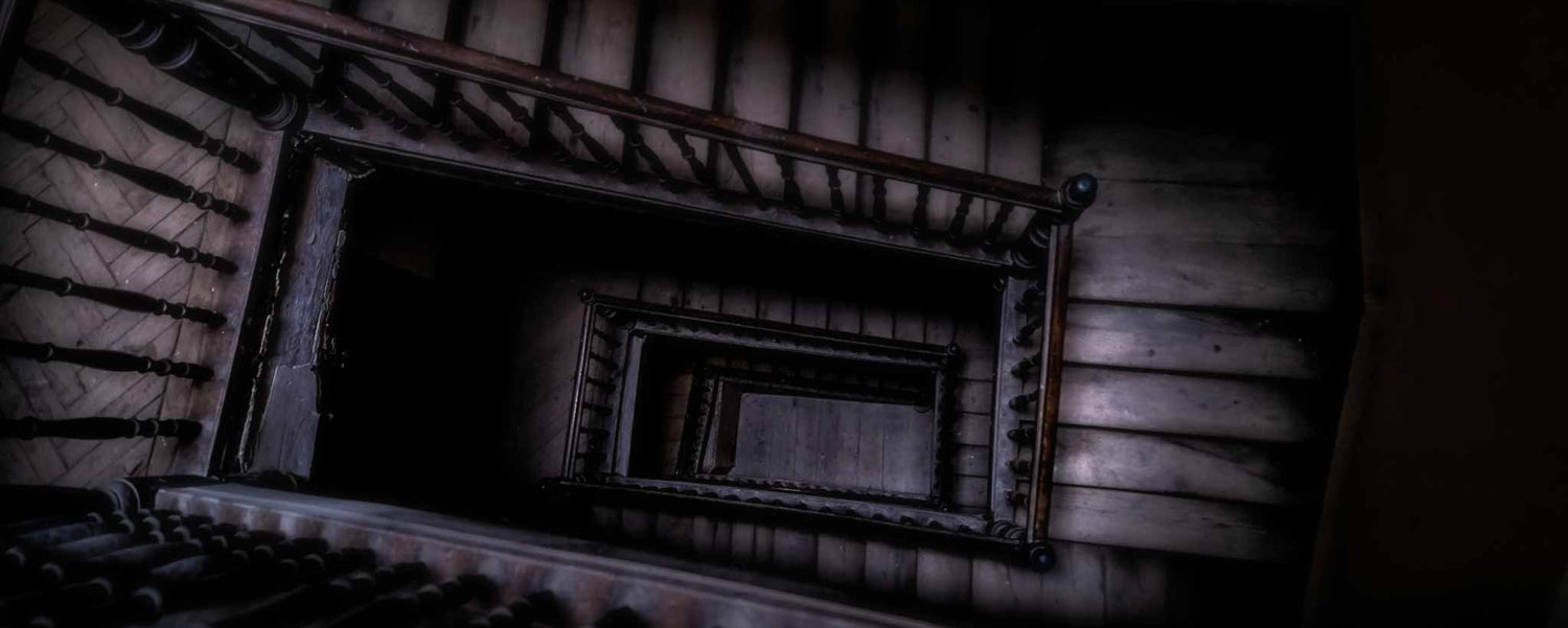 Looking down a dark, spiraling stairway.