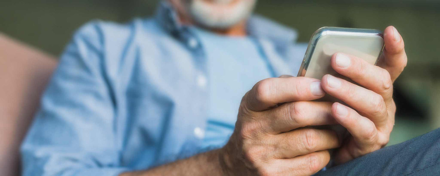 Elderly man holding smartphone