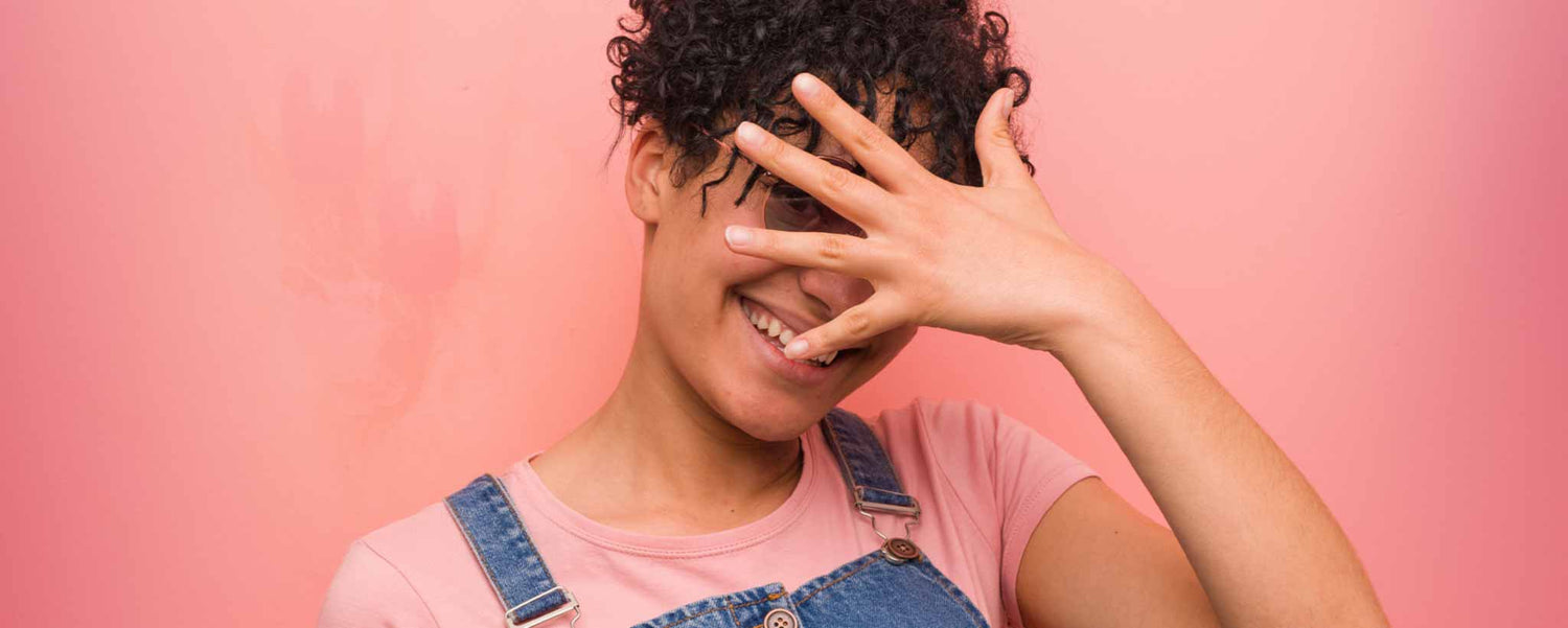 Embarrassed young lady covering face