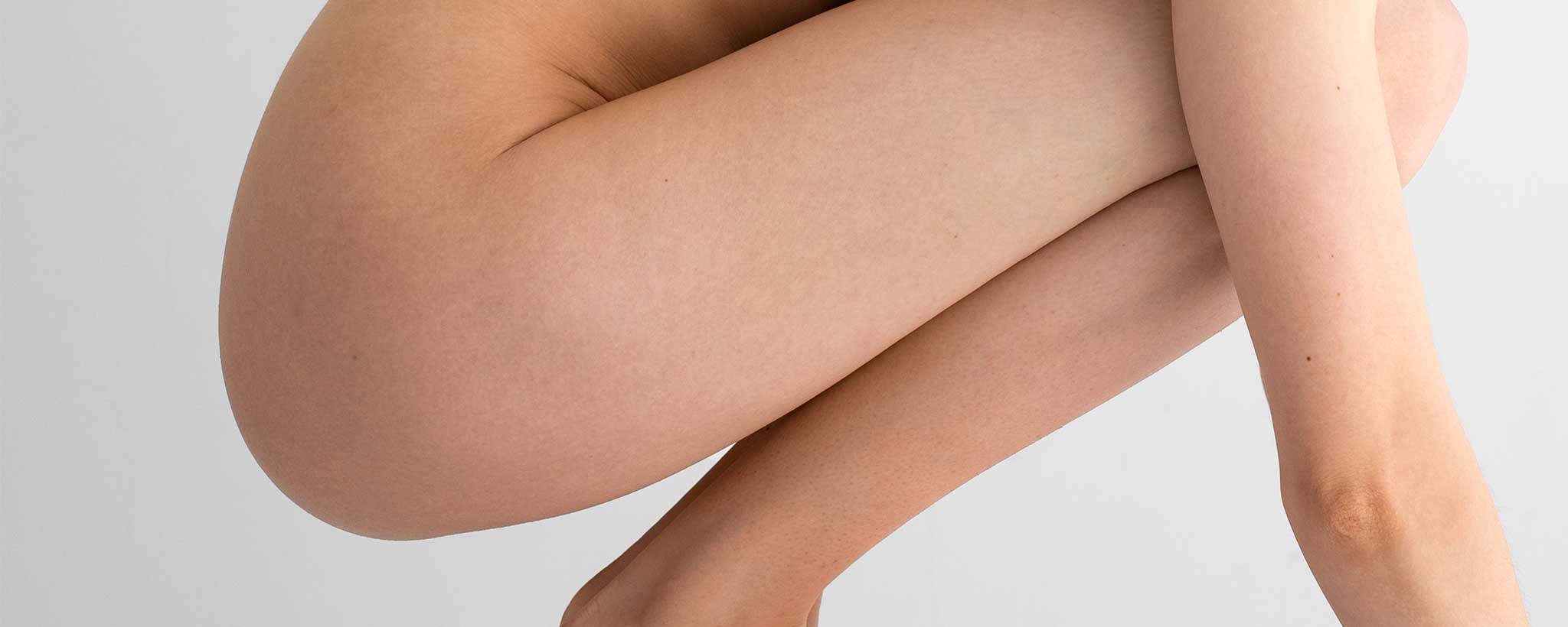 'Profile of kneeling female buttocks'