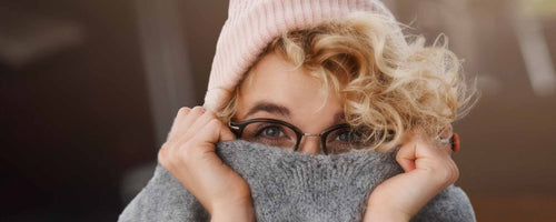 Woman hiding behind sweater