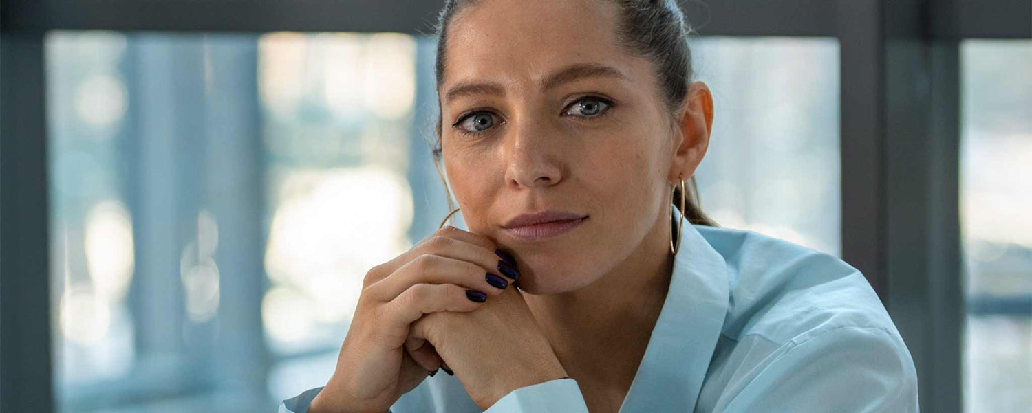 A professional female sitting in an office.