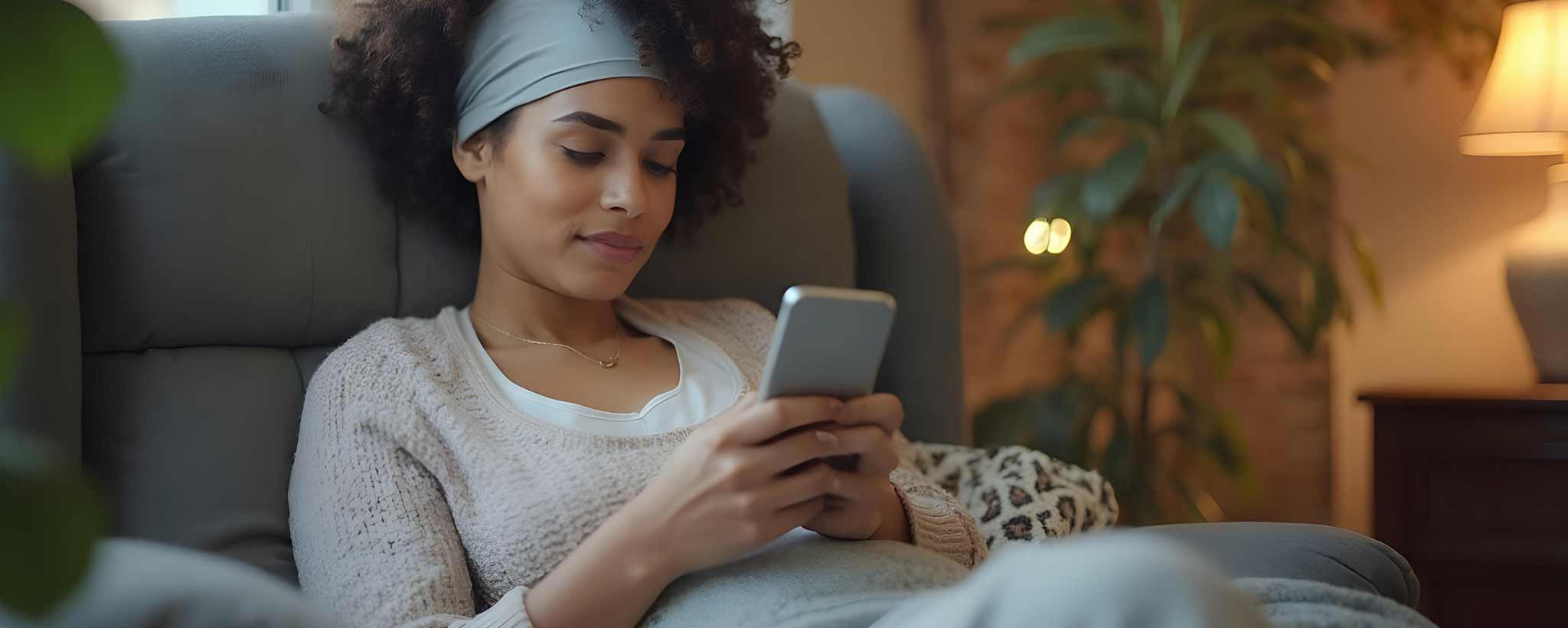 'A recovering lady sits in a recliner with her phone. (ai)'