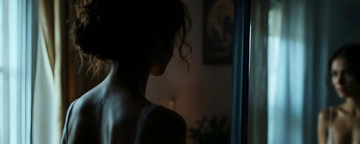 'Reyna gazes at her reflection, wondering if she could ever attract a man. (ai)'