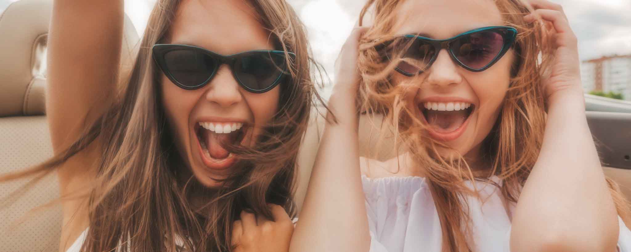 'A couple of happy females on a convertible road trip,'