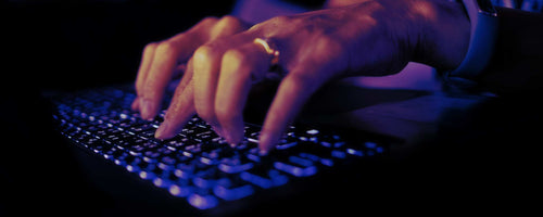 Female hand typing on keyboard