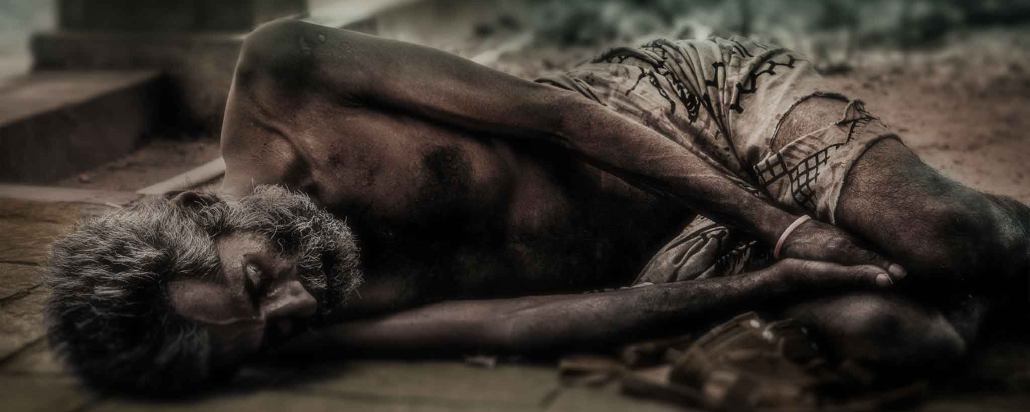 'Homeless man laying on street'