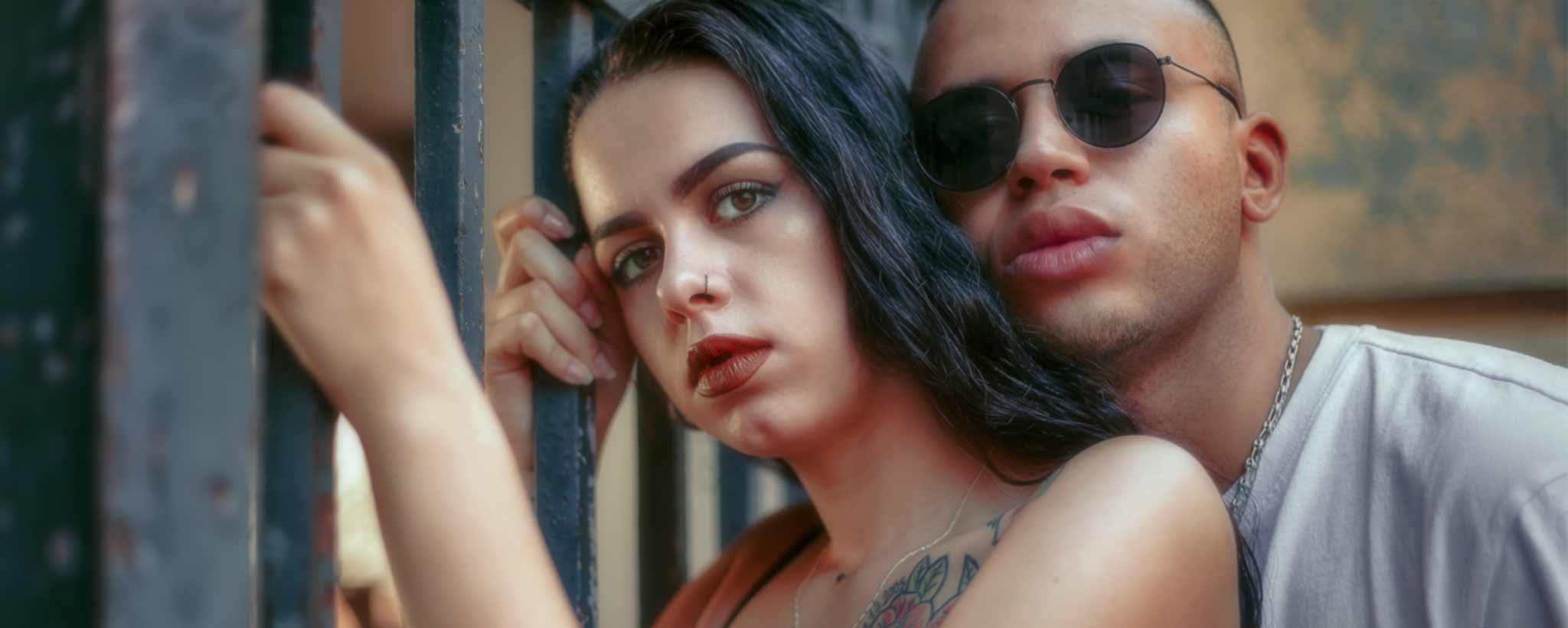 'A gang couple by a gate.'