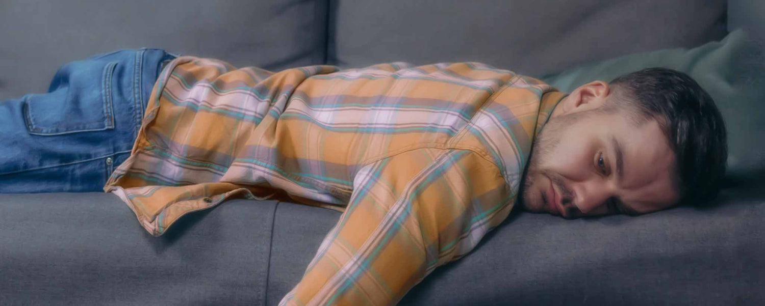Fatigued man on sofa