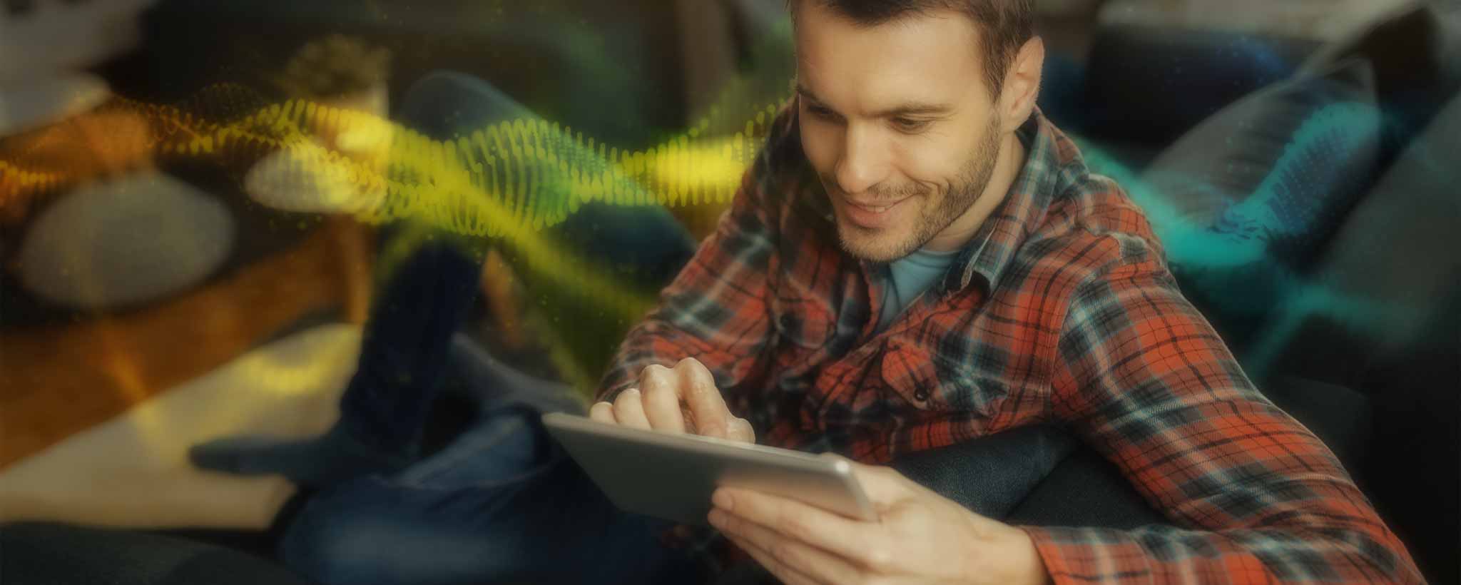 'Man with digital tablet on sofa'