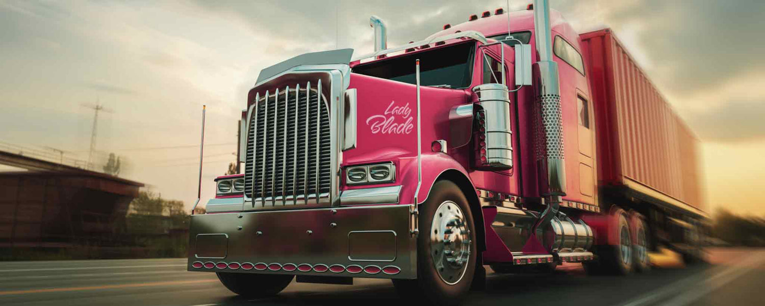 Bright red Lady Blade 18-wheel truck rolling down the highway.