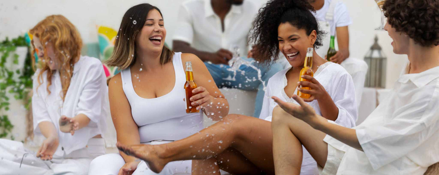A group of women is enjoying a casual outdoor gathering with drinks.