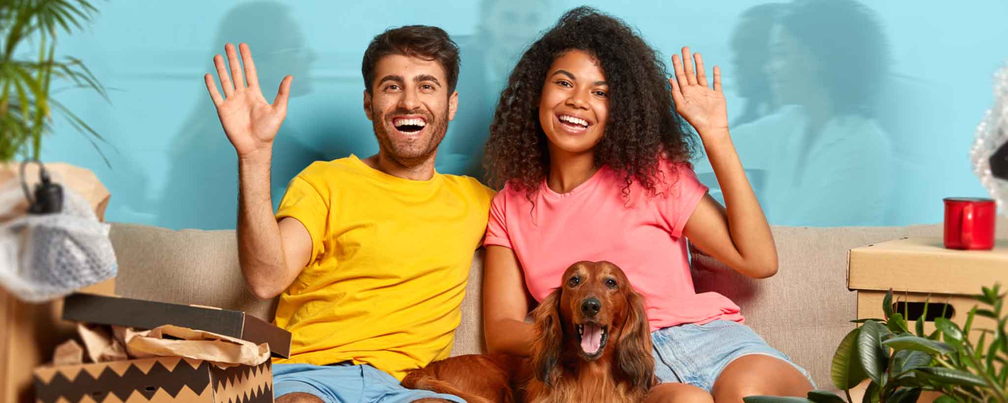 'Interracial couple sitting on sofa'