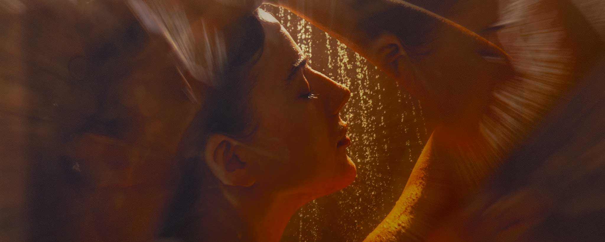 'A female face profile while showering.'