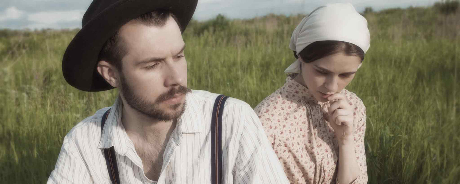 A married couple in a rural field.