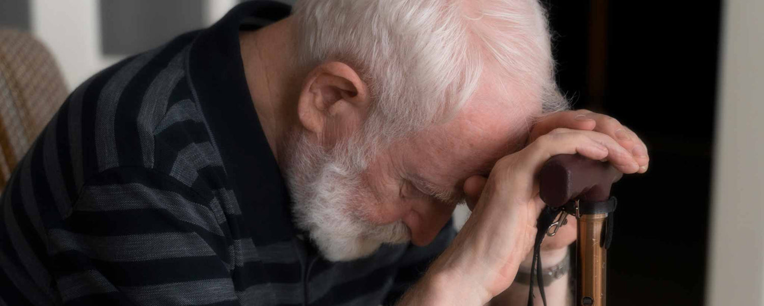 Senior man bows head