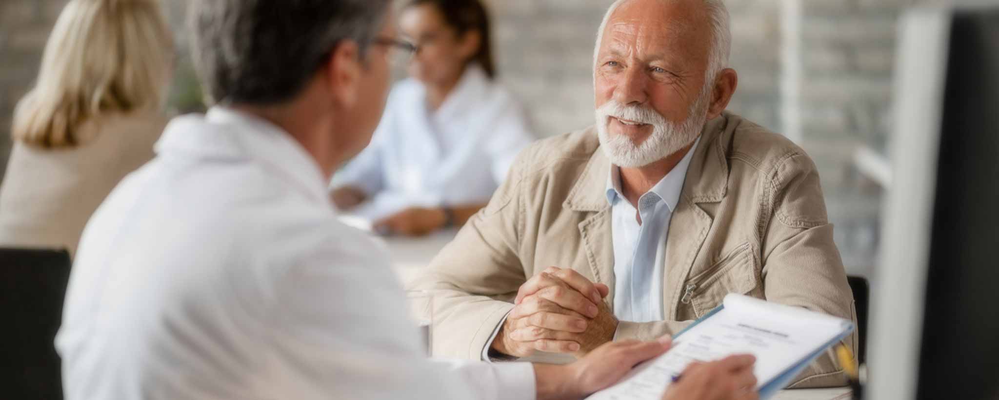 'Senior patient consulting with doctor'