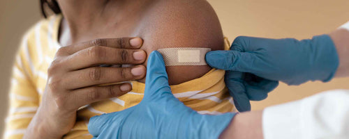 African American woman bandaged after vaccine