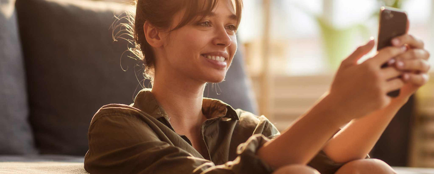 Smiling female viewing phone