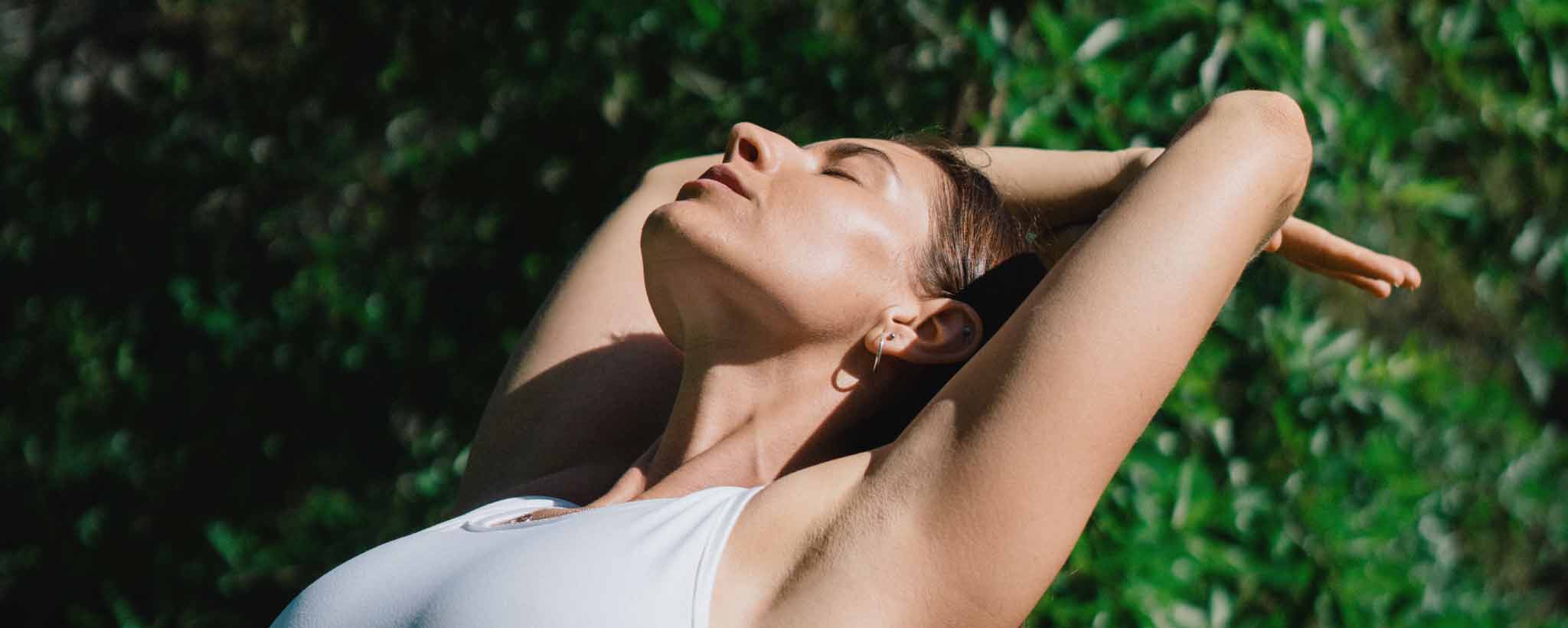 'Healthy woman stretching outdoors'