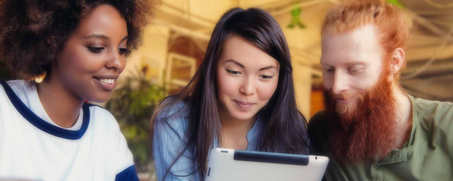 Three students view electronic tablet