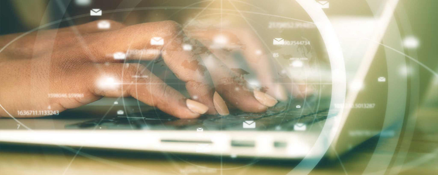 Fingers typing on laptop keyboard