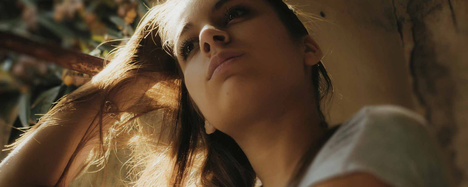 A thoughtful female teen near a window. (ai)