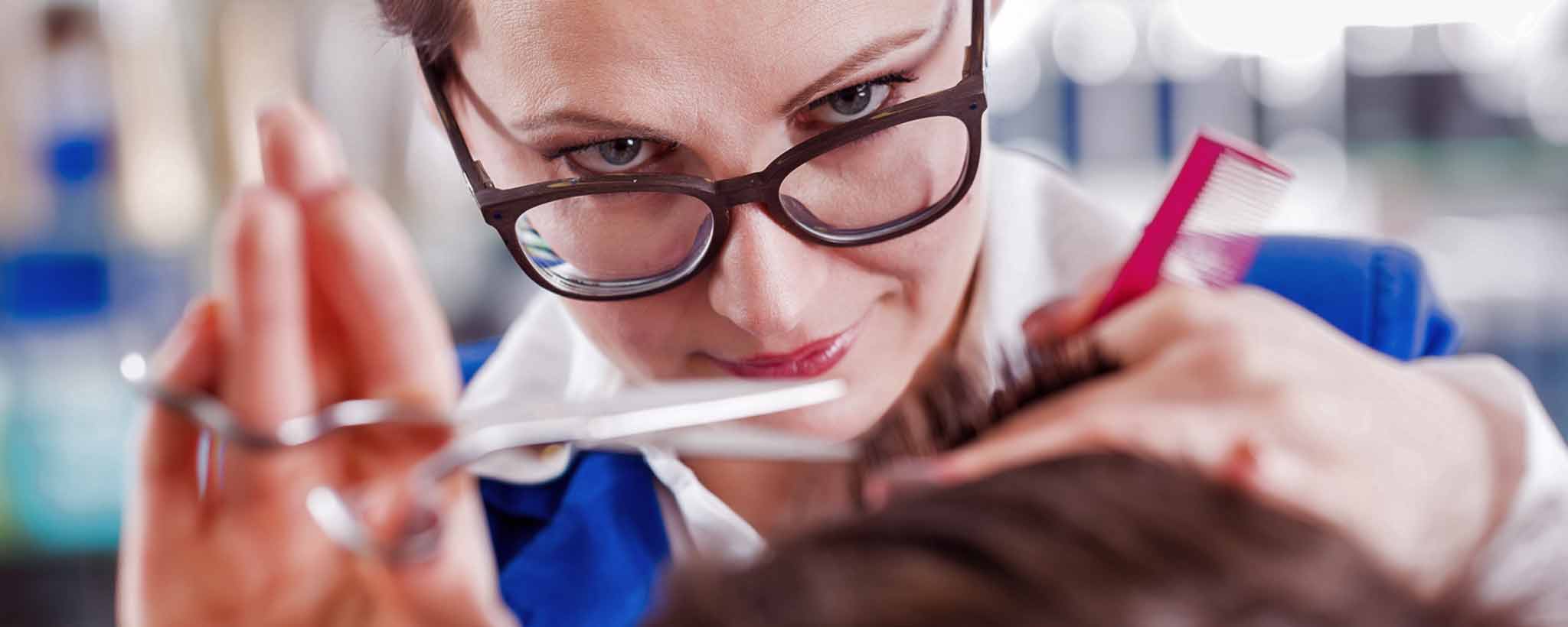 'Hairstylist trimming hair'