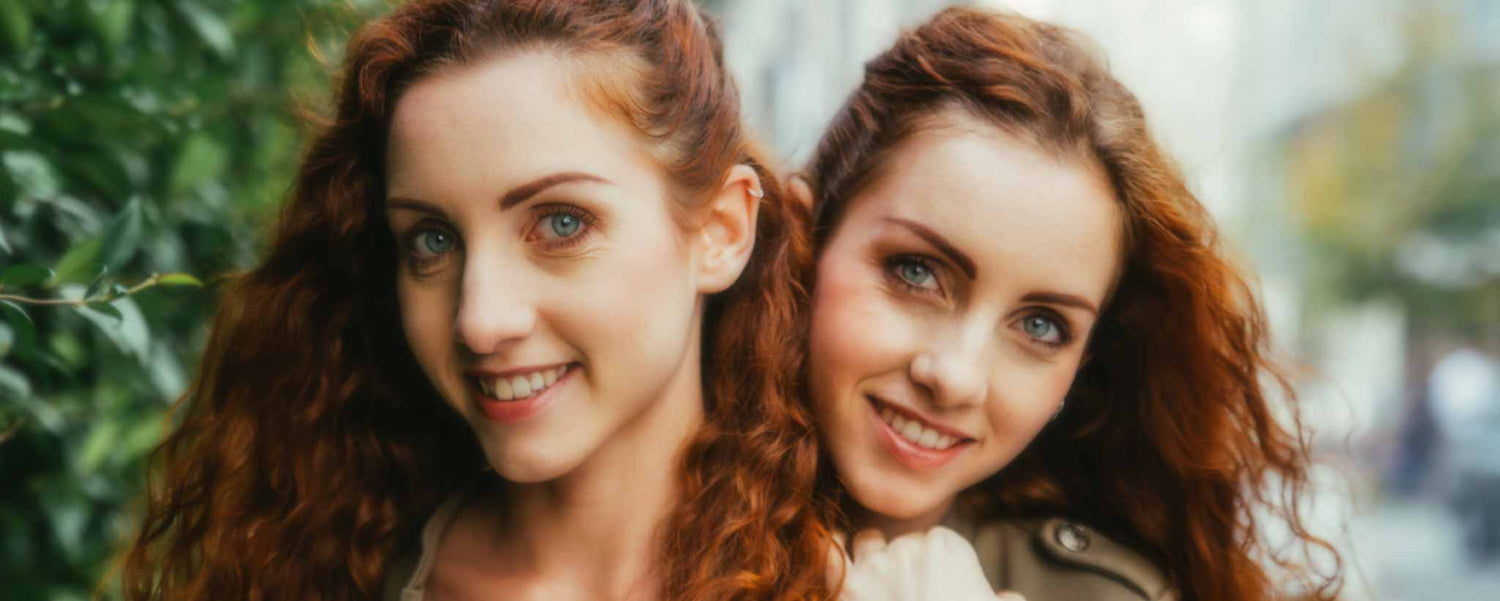 Smiling adult redhead twins