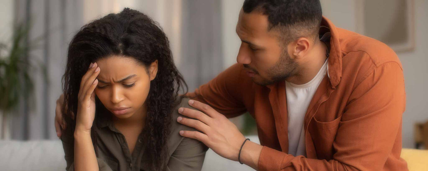 Man consoling woman