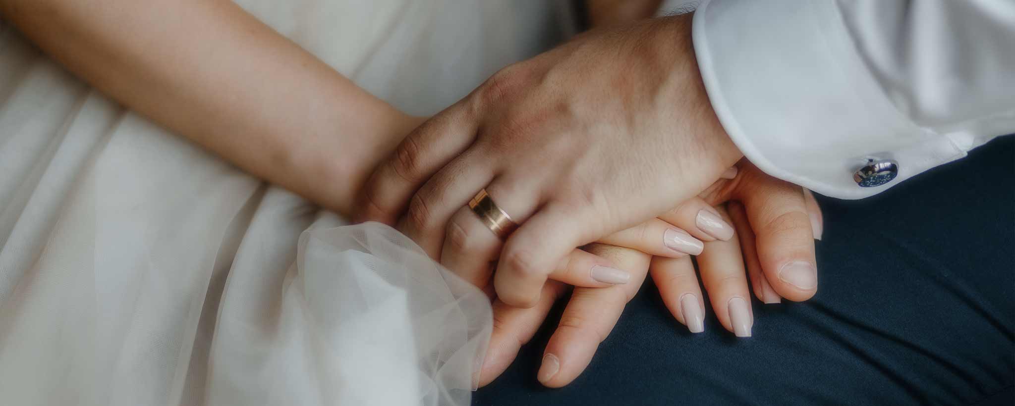 'Wedding couple holding hands'