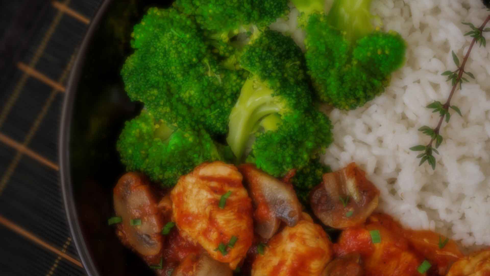 Chicken and mushrooms in tomato sauce with broccoli over rice
