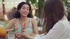 Two women enjoy an outdoor conversation.