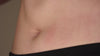 A lady's hands jiggling her belly.